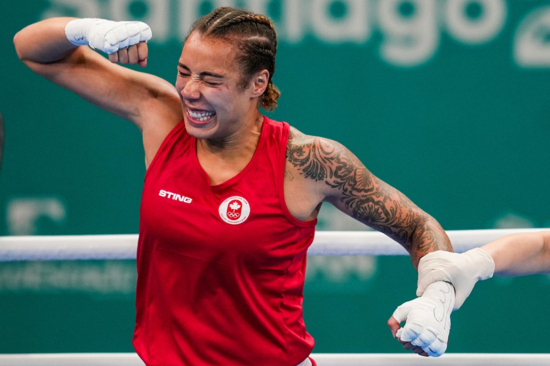 Tammara Thibeault pumps her arm as she is announced winner of the bout