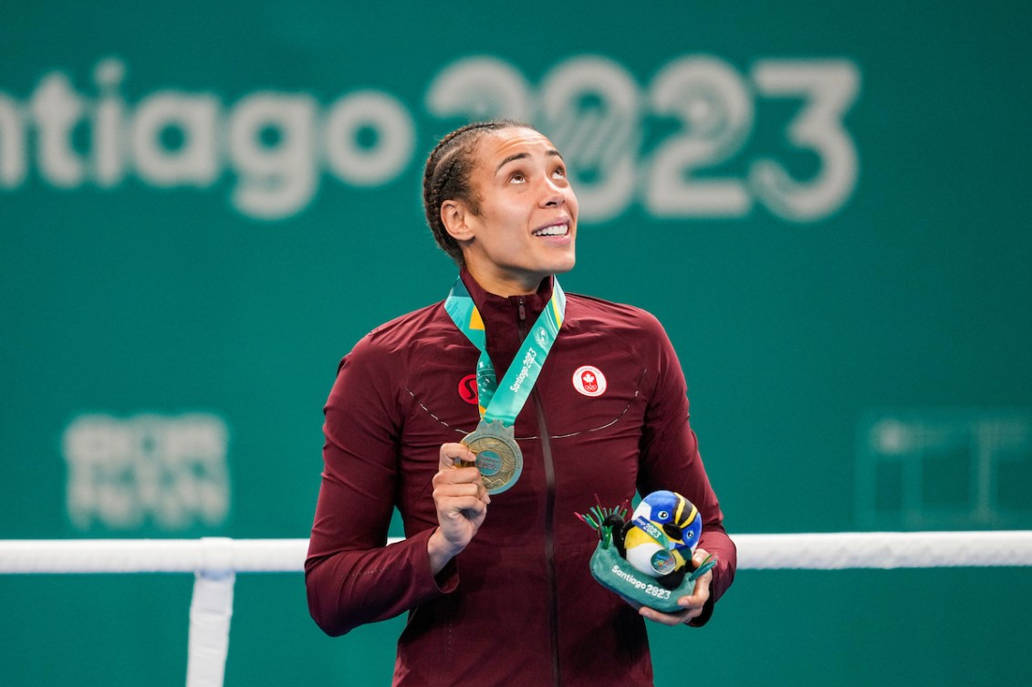 Tammara Thibeault looks to the sky while wearing a gold medal