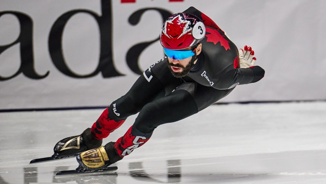 Steven Dubois, a male short track speed from Canada makes a turn.