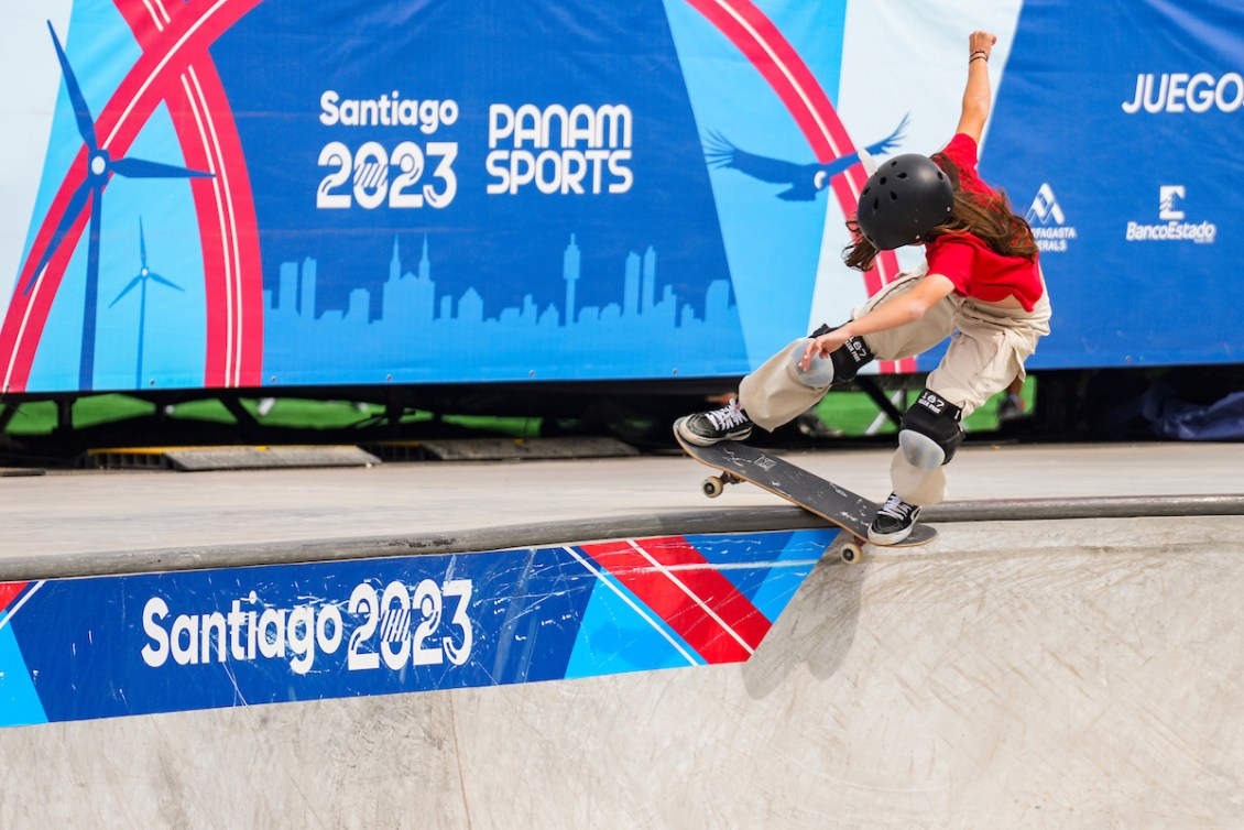 Fay De Fazio Ebert slides her skateboard along the top of the park ramp