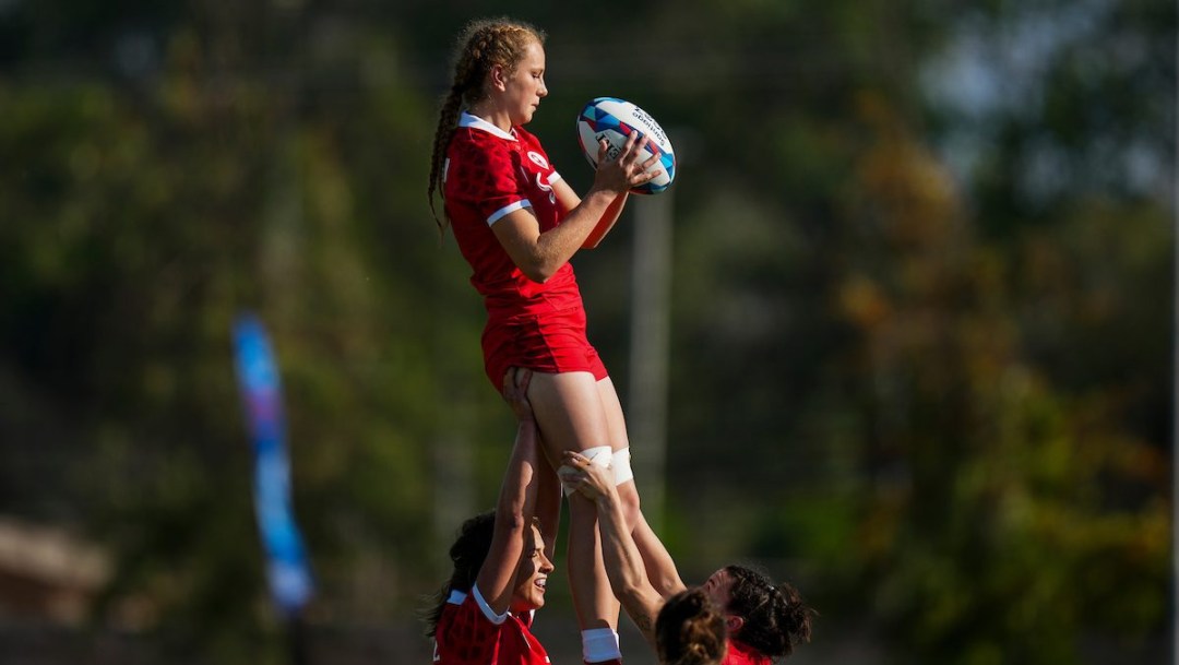 Carissa Norsten is hoisted into the air by her teammates