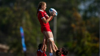 Carissa Norsten is hoisted into the air by her teammates