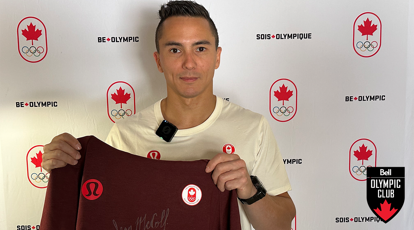 Sean McColl holding up a signed sweater