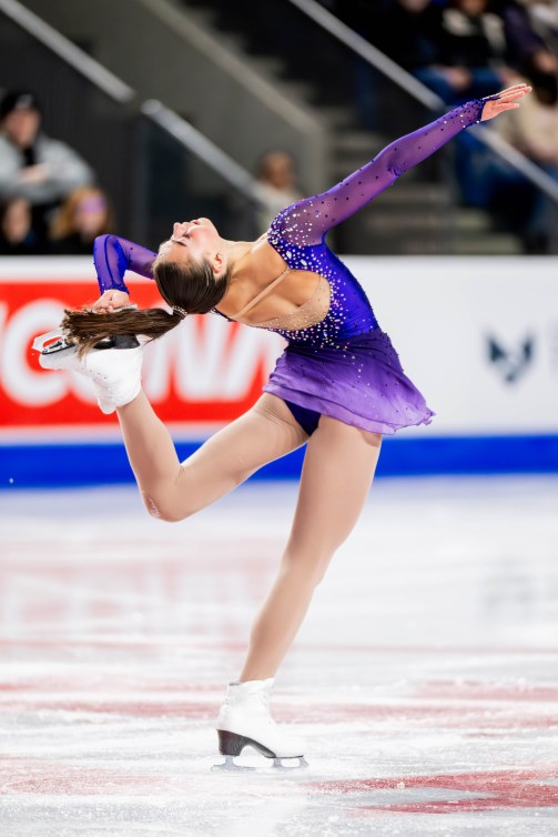 Kaiya Ruiter holds her skate behind her head while spinning