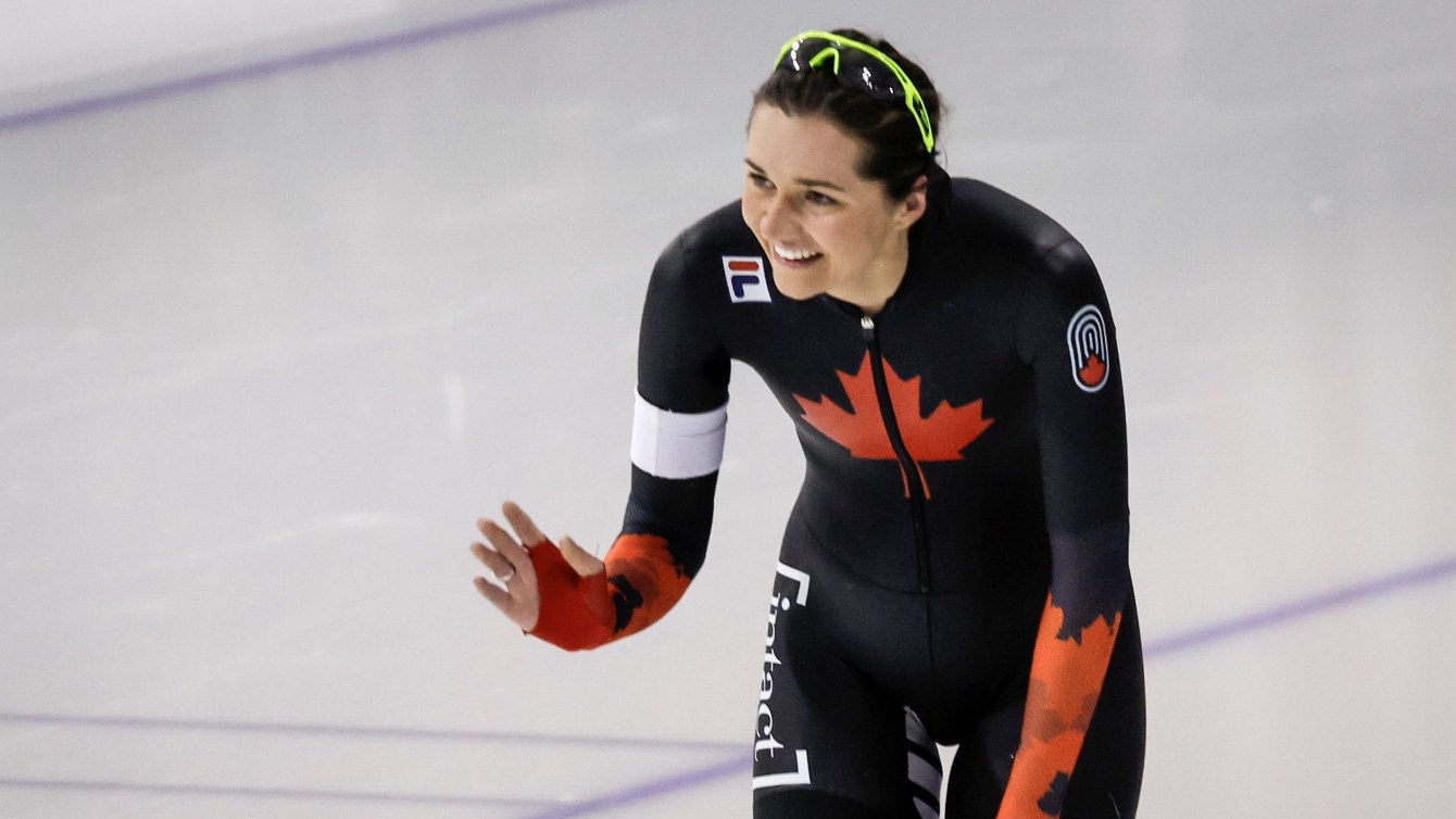 Isabelle Weidemann waves at the end of a speed skating race