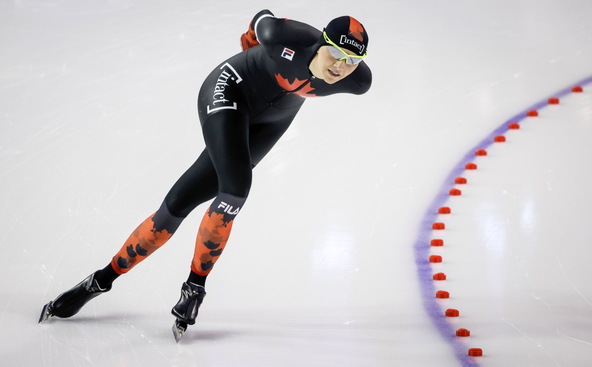 Isabelle Weidemann rounds a corner in a speed skating race 