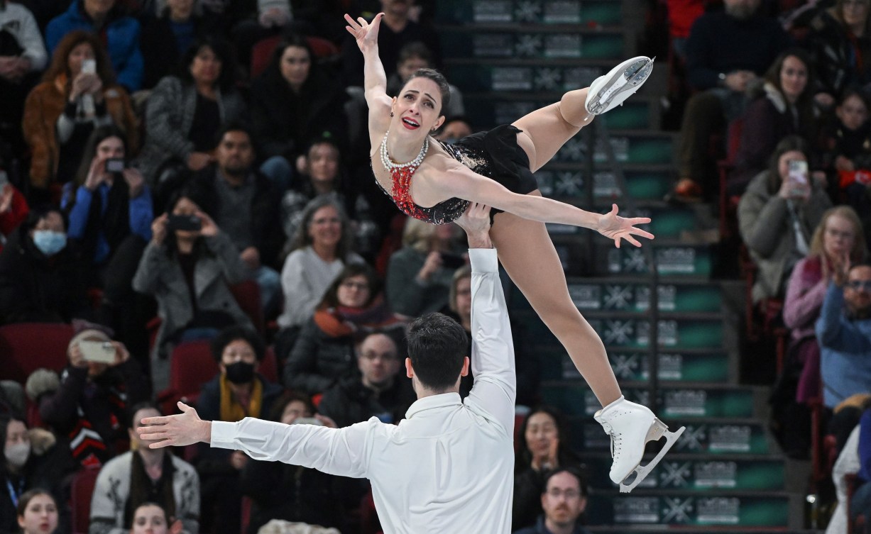 Deanna Stellato-Dudek lies atop Maxime Deschamps arm in a pair lift 