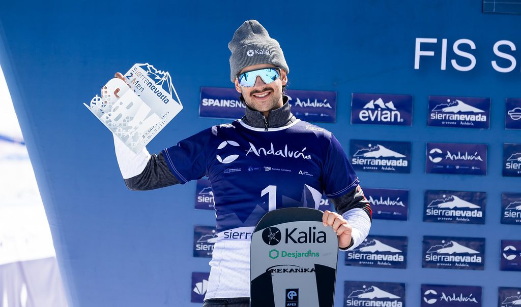 Canadian snowboarder Eliot Grondin smiles with trophy after finishing second at the FIS Snowboard Cross World Cup i Sierra Nevada, Spain.