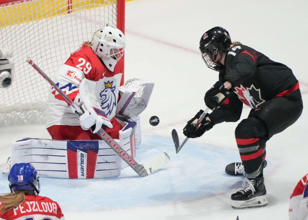 Czechia goaltender Klara Peslarova makes a save against Canada's Renata Fast during first period semifinal hockey action at the IIHF Women's World Hockey Championship in Utica, N.Y., Saturday, April 13, 2024.