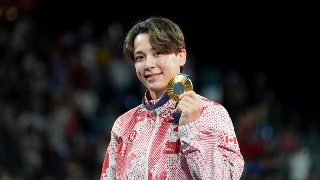 Christa Deguchi holds up her gold medal