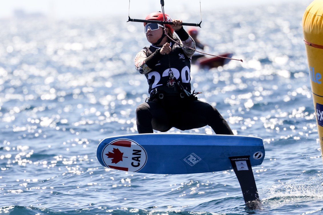 A kiteboarder races on the ocean