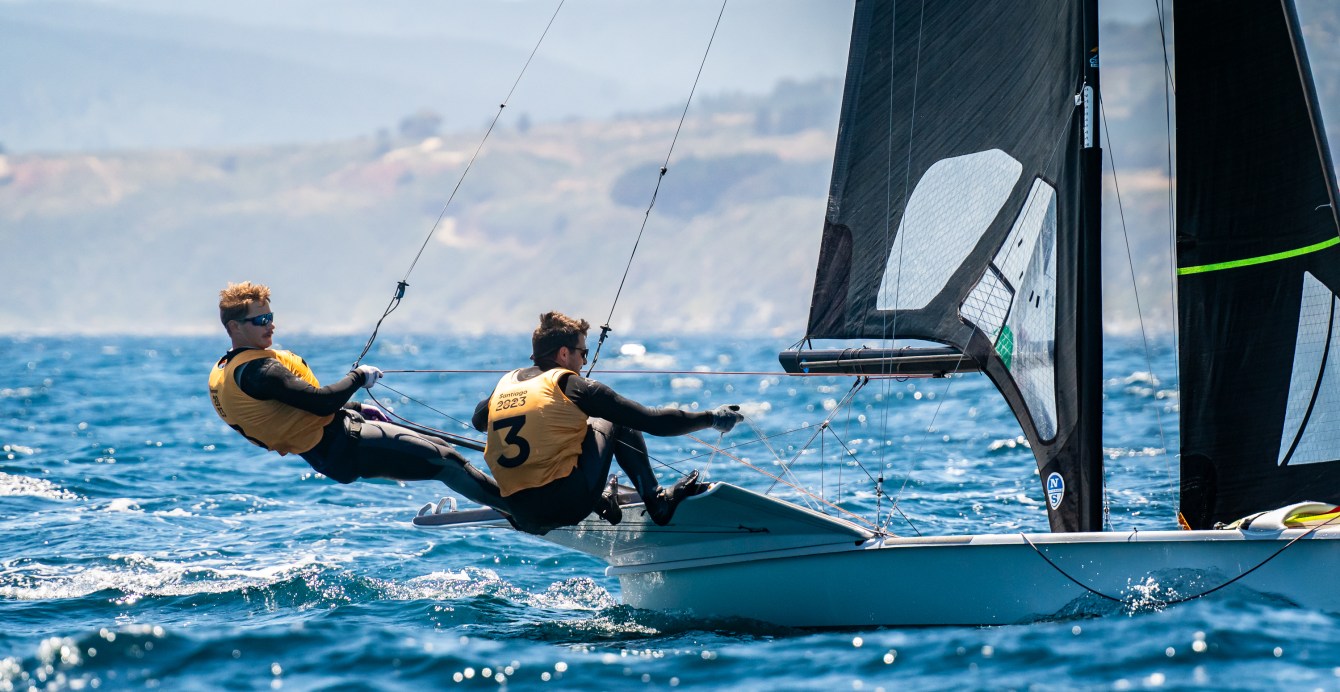 Two sailors lean out on trapeze