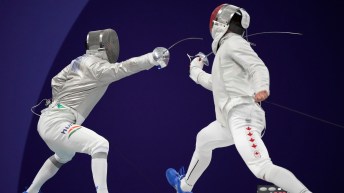 Two fencers lunge at each other