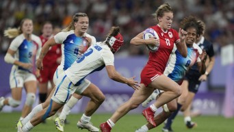 Canada's Piper Logan drives on to score a try during the women's quarterfinal Rugby Sevens match between France and Canada at the 2024 Summer Olympics, in the Stade de France, in Saint-Denis, France, Monday, July 29, 2024. (AP Photo/Tsvangirayi Mukwazhi)