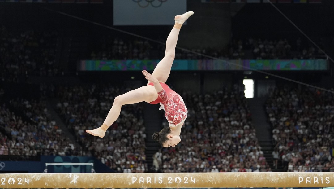 Ava Stewart performs on the balance beam