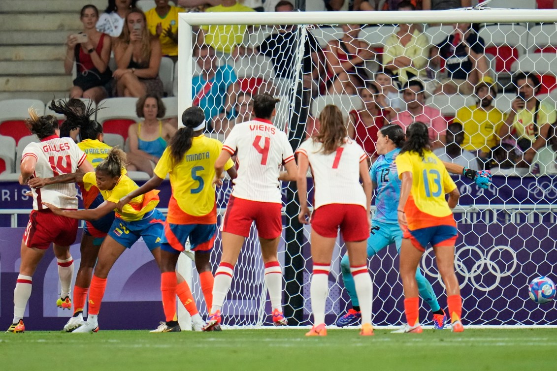 Vanessa Gilles scores a headed goal against Colombia.