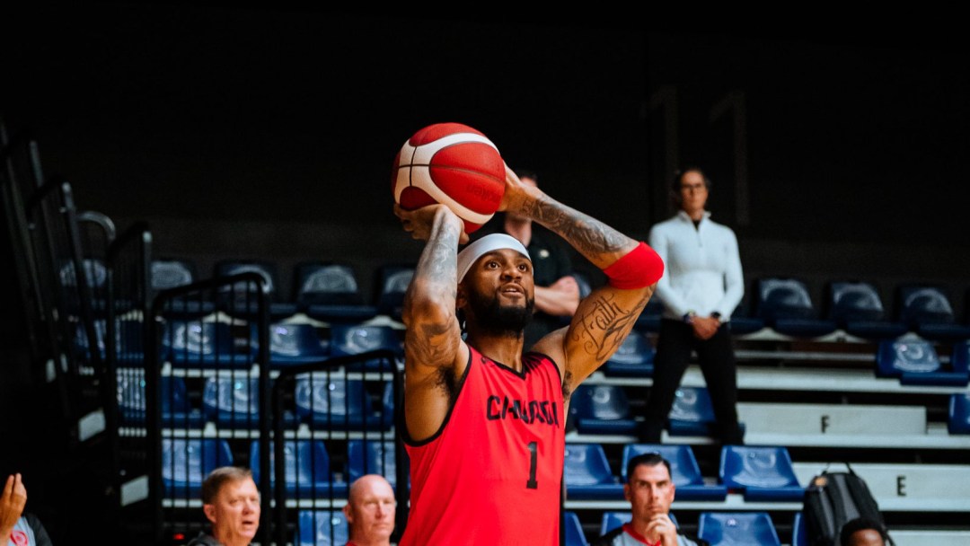 Nickeil Alexander-Walker takes a shot while wearing a red jersey