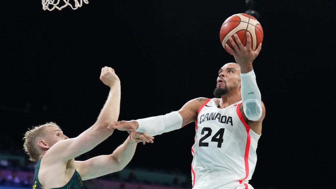 Dillon Brooks drives for a layup while wearing a white uniform