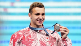 Ilya Kharun holding his silver medal