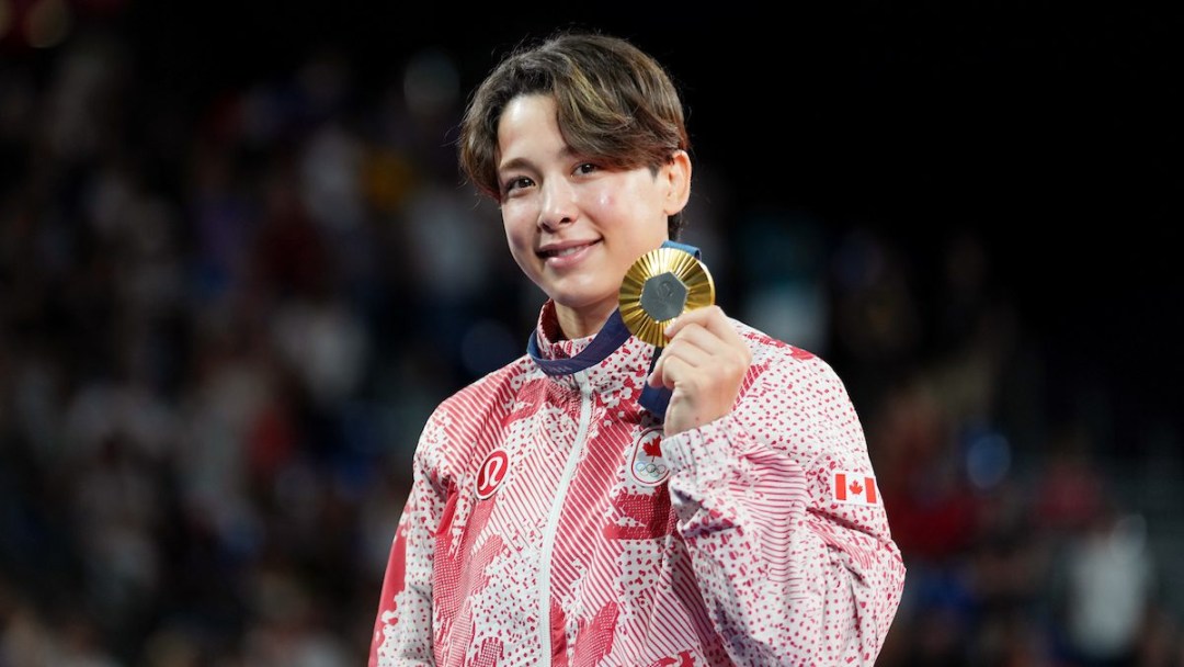 Christa Deguchi holds up her gold medal