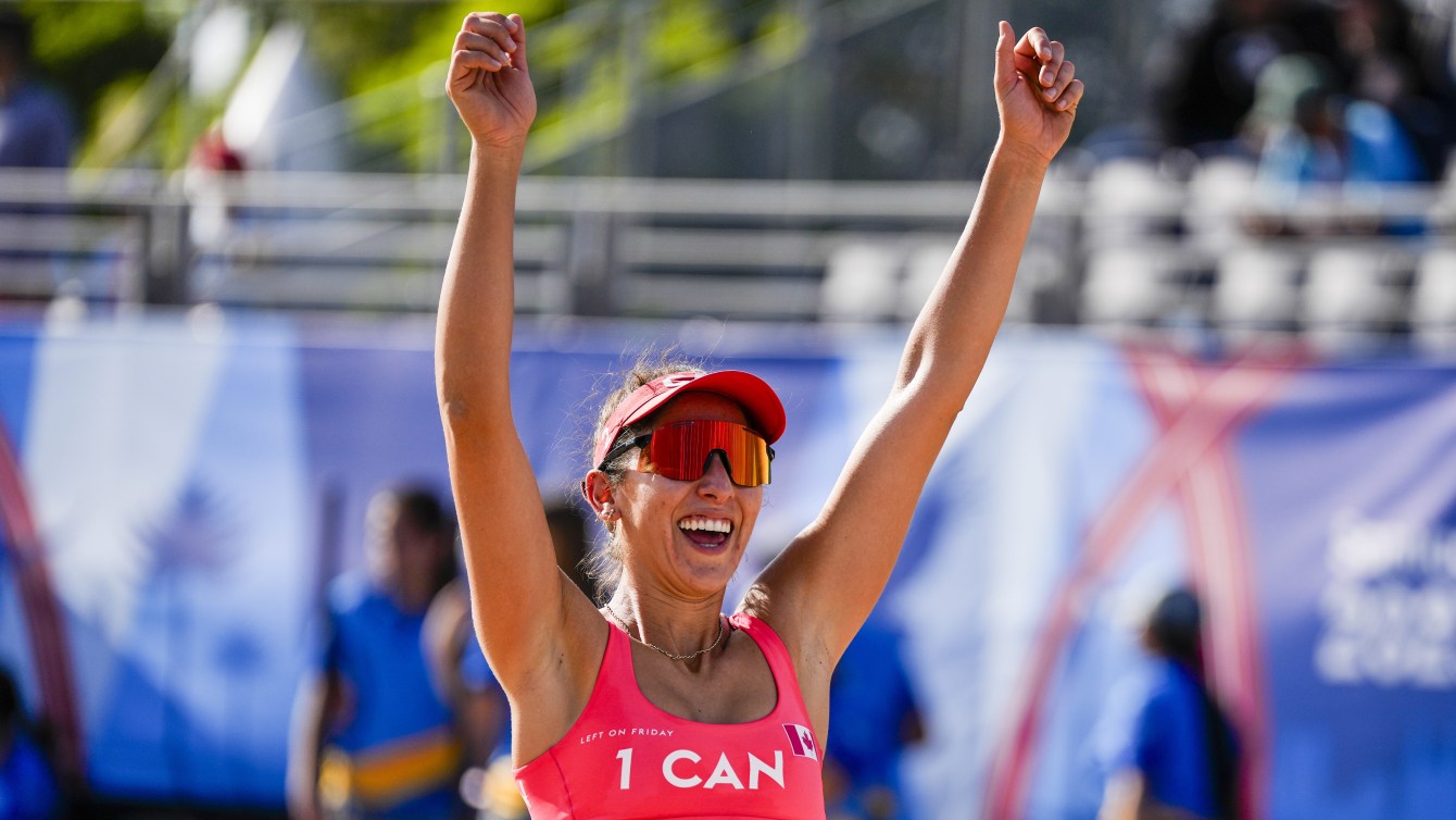 Melissa Humana-Paredes  raises her hands in celebration