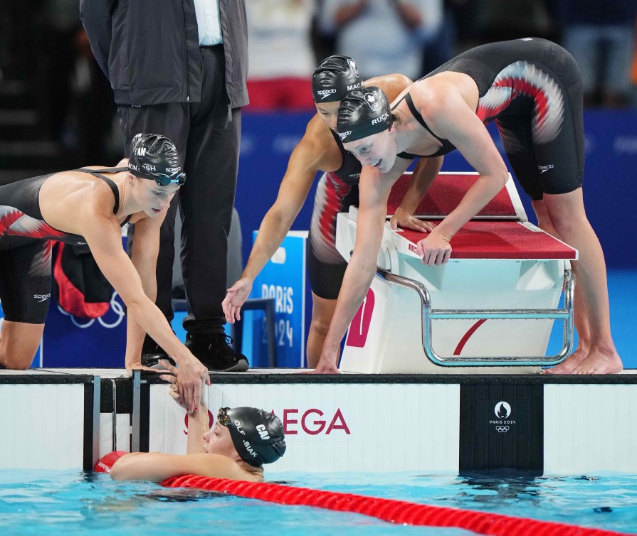 Team Canada's women's relay team gives high fives after race.