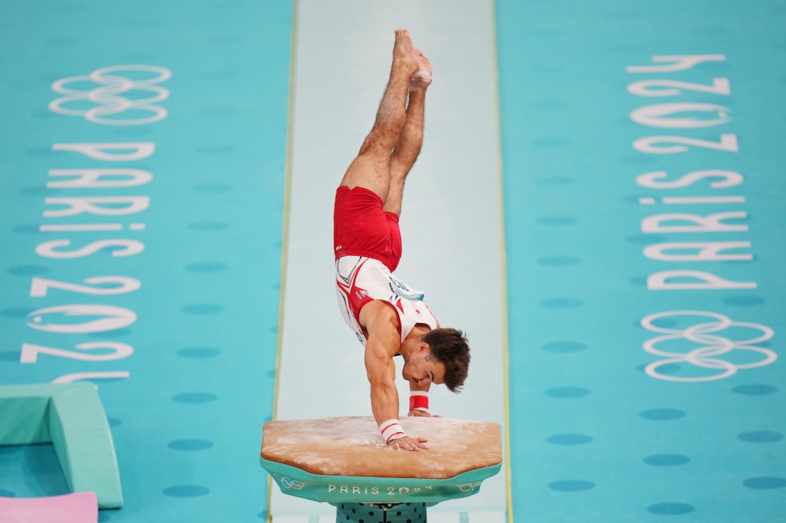 William Emard completes a flip over a vault 