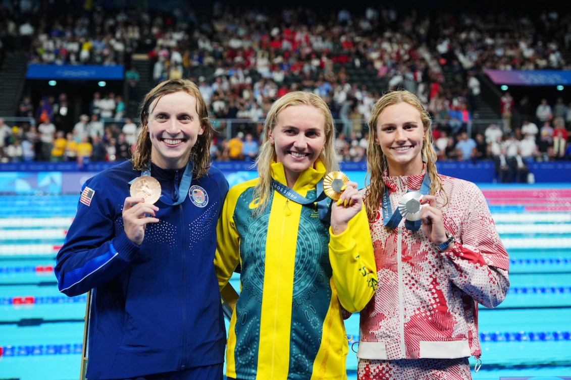 Summer McIntosh, Ariarne Titmus and Katie Ledecky show their medals.