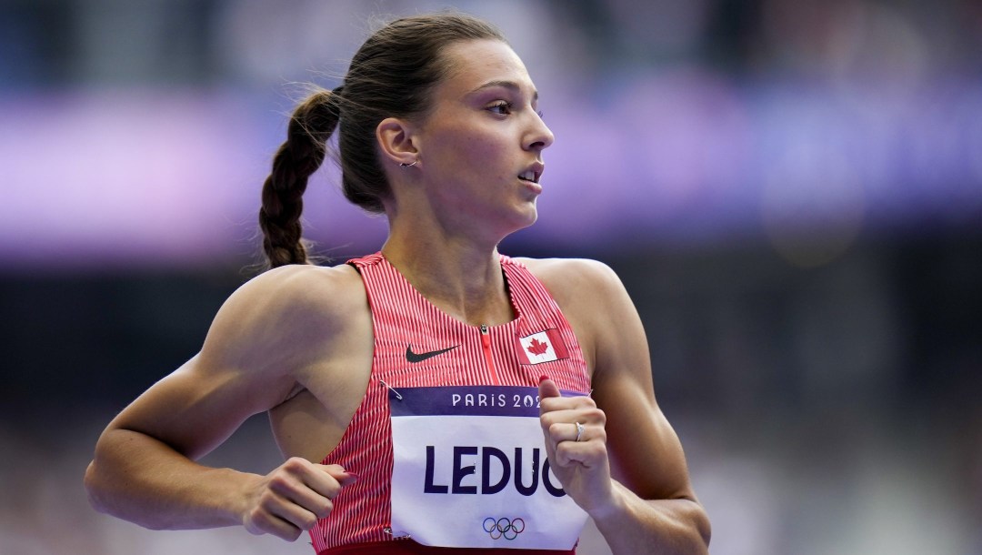 Audrey Leduc, of Canada, wins a heat in the women's 100-meter run at the 2024 Summer Olympics, Friday, Aug. 2, 2024, in Saint-Denis, France. (AP Photo/Petr David Josek)