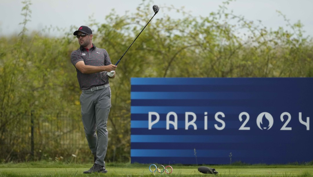 Corey Conners watches the flight of his ball