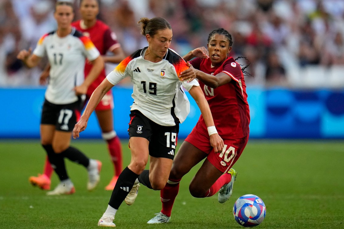 Ashley Lawrence battles for the ball against Germany.