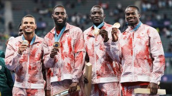 Canada's men's 4x100m relay team holds their gold medals