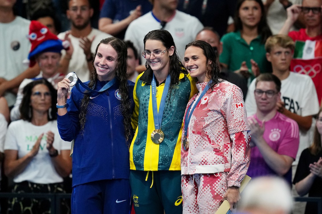 Kylie Masse poses with her bronze medal and fellow medalists