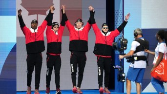 Team Canada’s men's 4x100m medley relay team raises their arms together