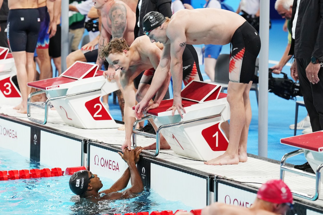 Team Canada’s men's 4x100m medley relay team reacts at the wall