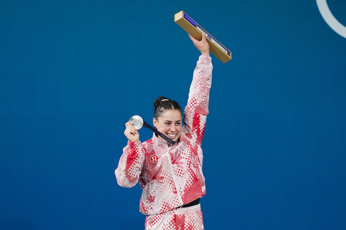 Maude Charron shows off her silver medal around her neck