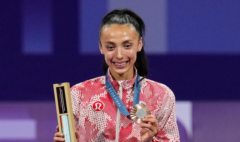 Skylar Park holds up her bronze medal 