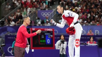 Skylar Park fist bumps her father and coach during competition