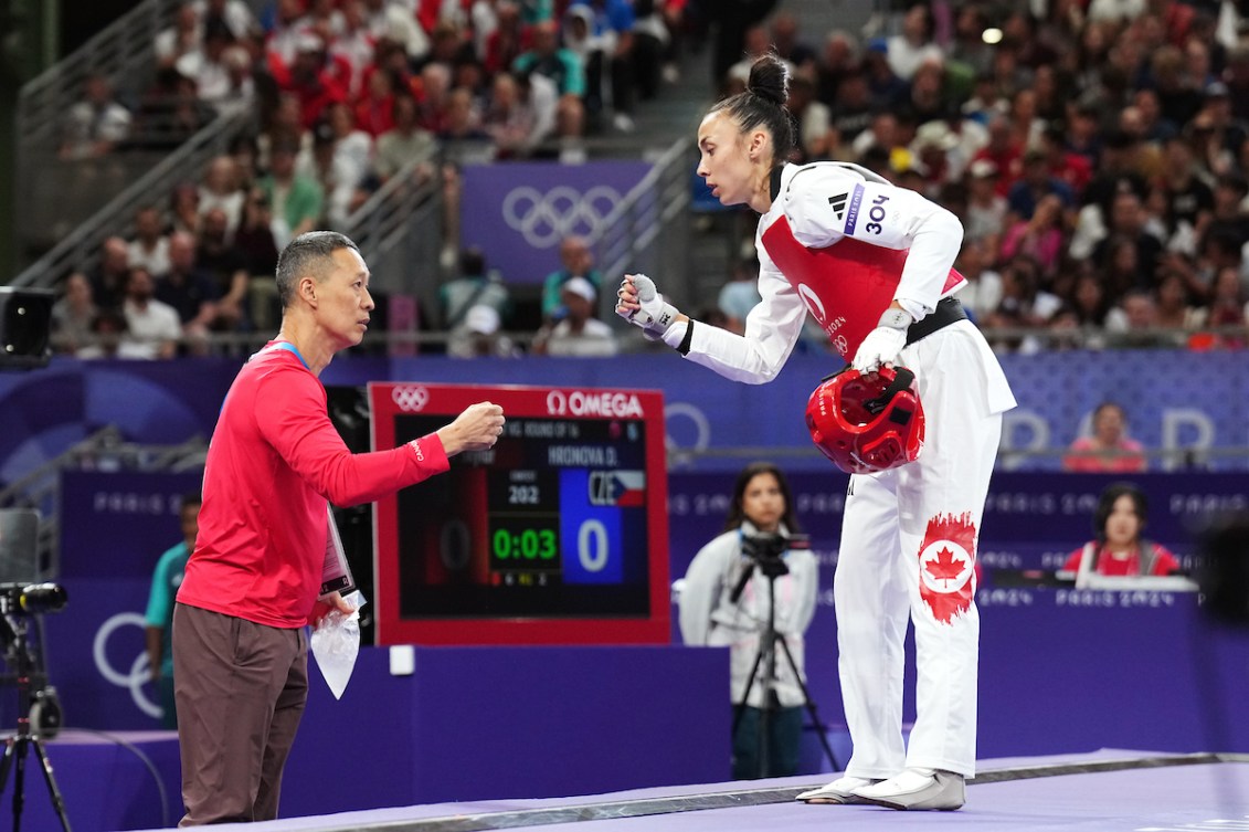 Skylar Park fist bumps her father and coach during competition