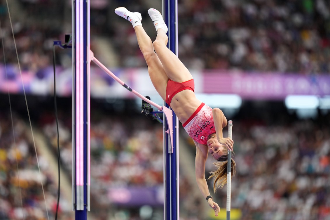 Alysha Newman flies over a bar in pole vault 