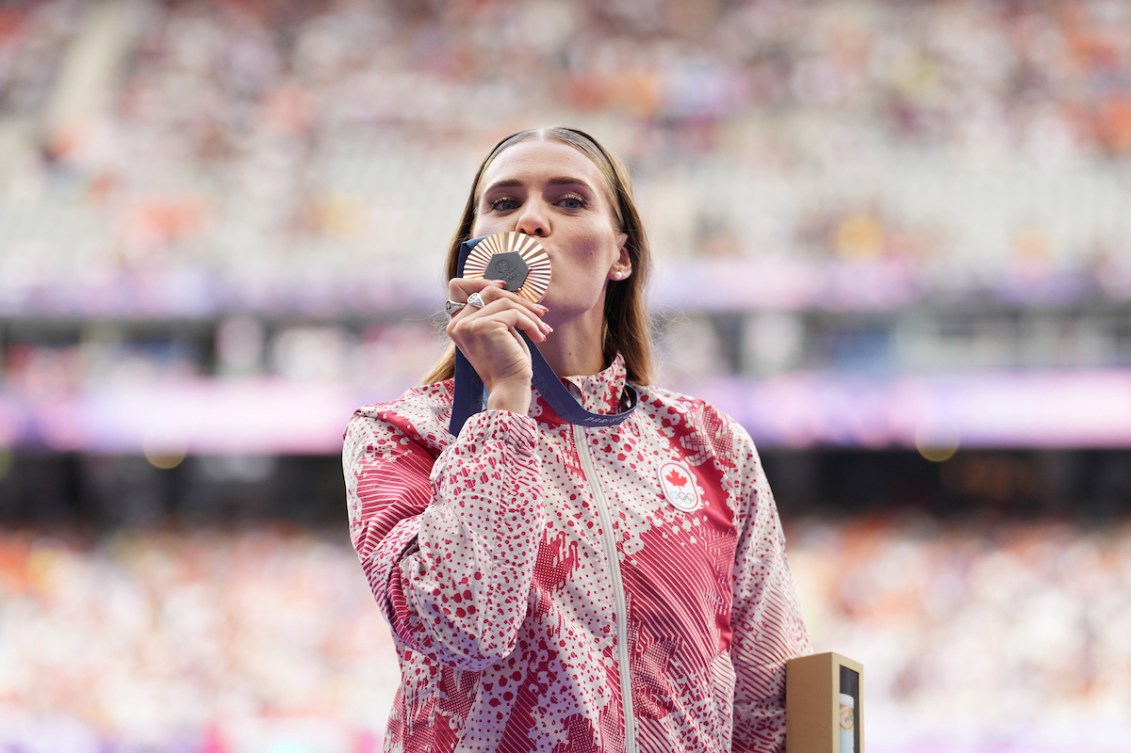 Alysha Newman kisses her bronze medal