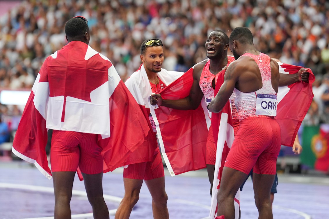 Team Canada celebrates after the men's 4x100m relay final.