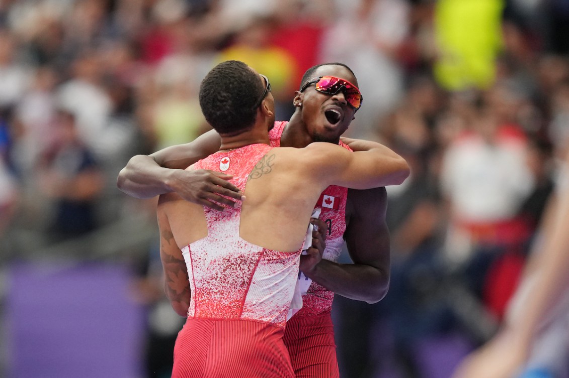 Andre De Grasse hugs Aaron Brown