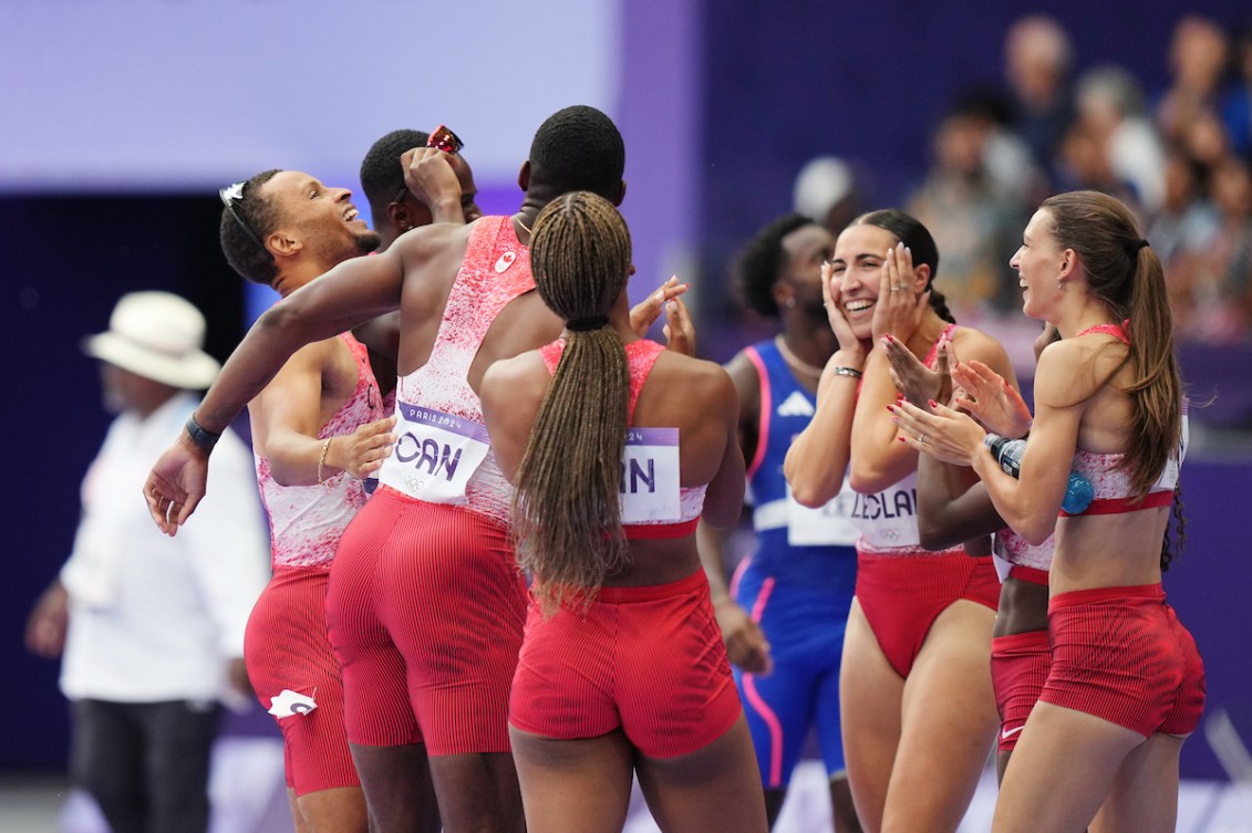 Canada's men's and women's 4x100m relay teams celebrate after the men's team won gold.