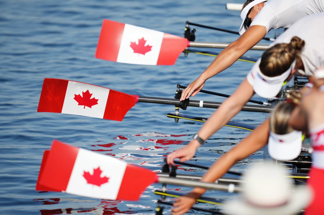 The Canadian flag is printed on rowing oars as athletes prepare their boat