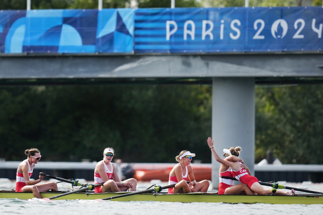 Kristen Kit leaps into the arms of a teammate while the women's eight members cry and celebrate