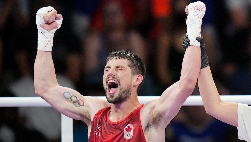 Wyatt Sanford raises his arms and yells after he wins his boxing match