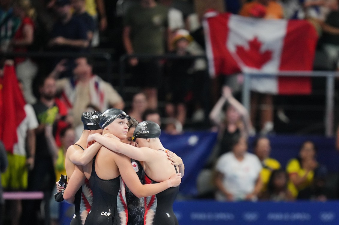 Team Canada’s 4x200m relay swim team huddles after a race