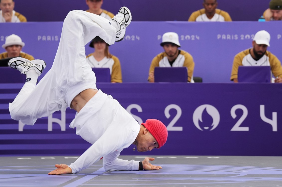 Phil Wizard contorts himself on a purple floor