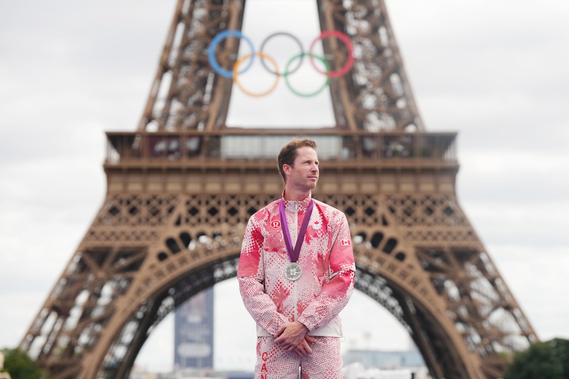 Derek Drouin stands with his silver medal in front of the Eiffel Tower 